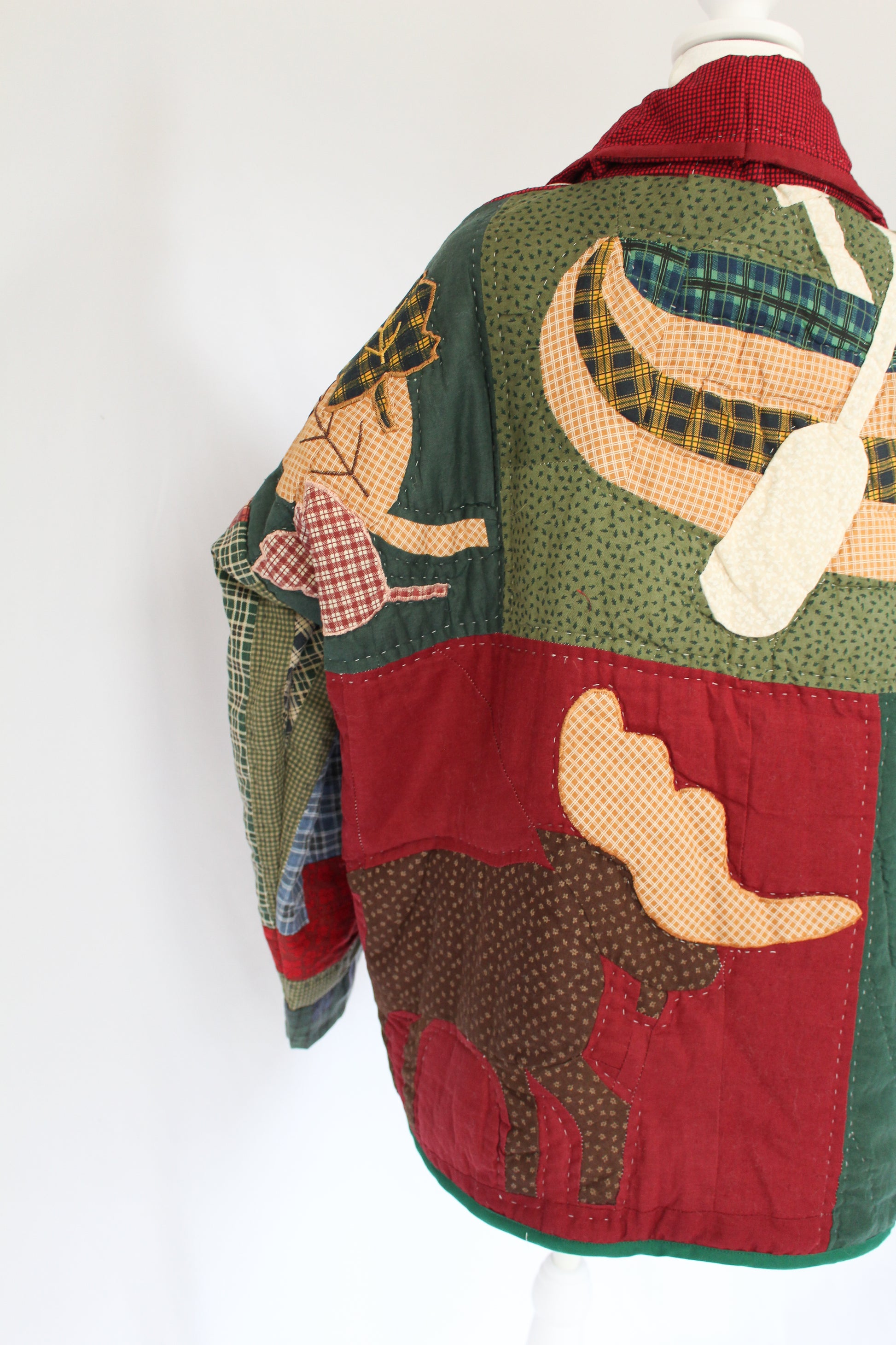 moose on the back of a quilt jacket, along with a canoe and leaves