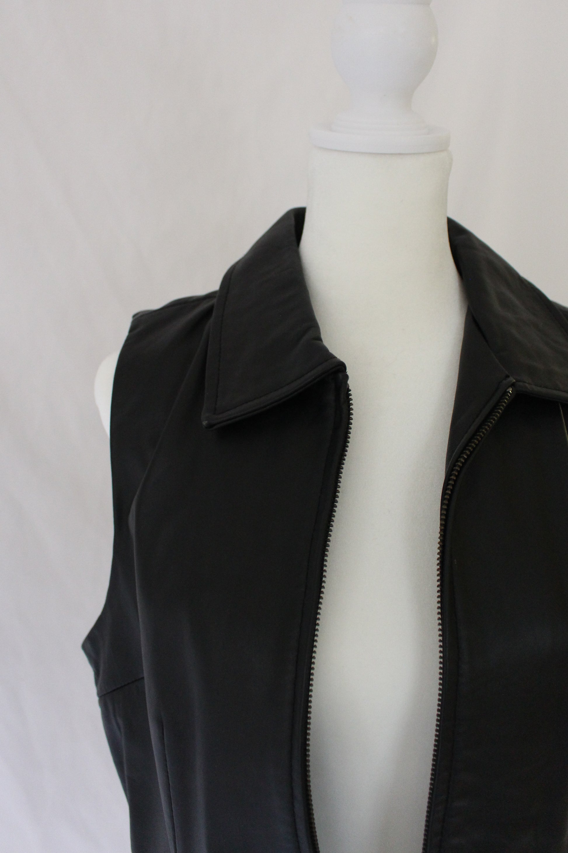 collar on black leather vest