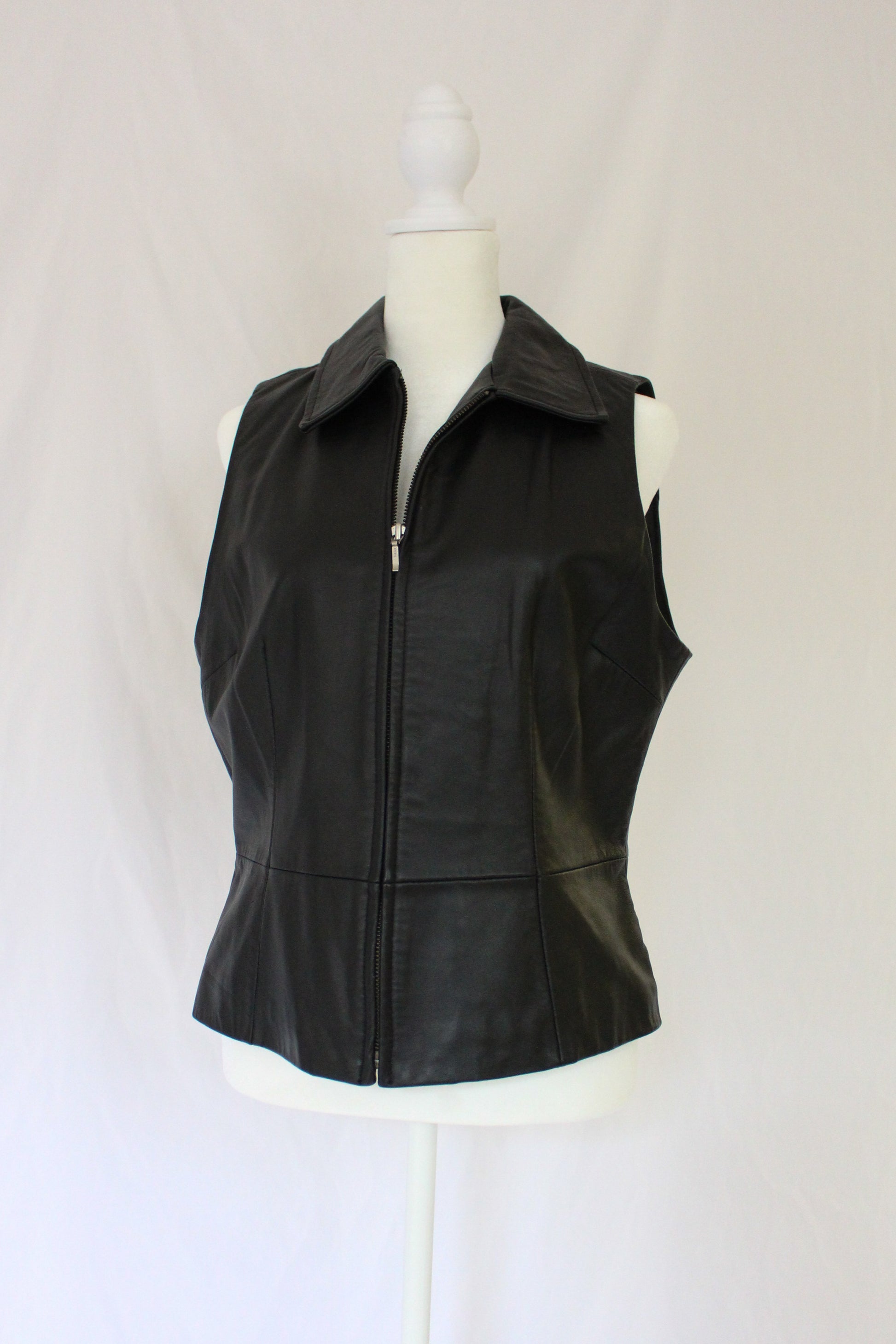 zipped up black leather vest